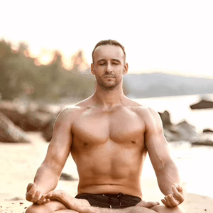 Man meditating on the beach